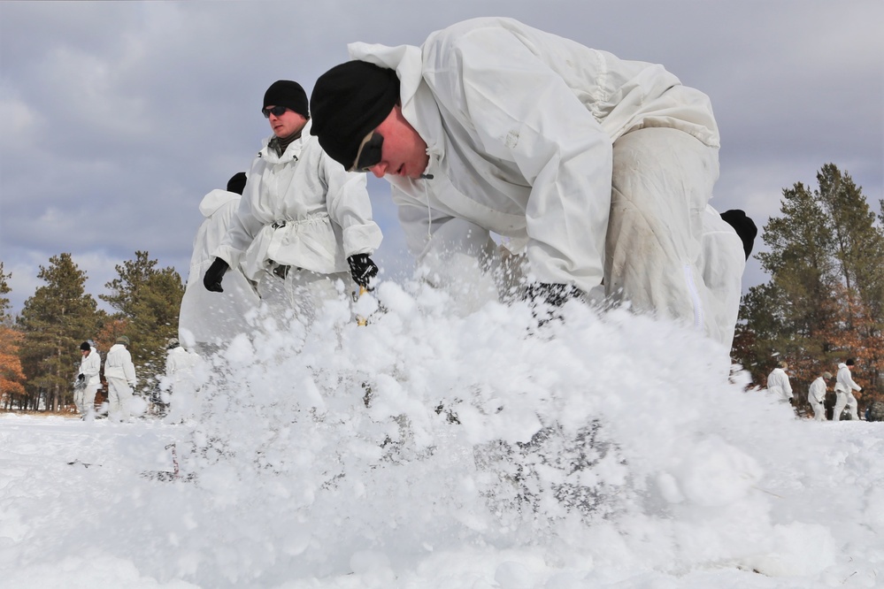 Cold-Weather Operations Course Class 18-06 students build Arctic tents during training at Fort McCoy