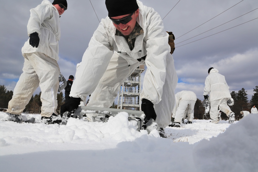 Cold-Weather Operations Course Class 18-06 students build Arctic tents during training at Fort McCoy