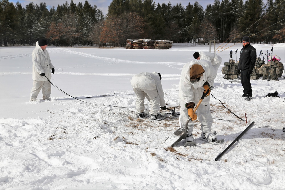 Cold-Weather Operations Course Class 18-06 students build Arctic tents during training at Fort McCoy