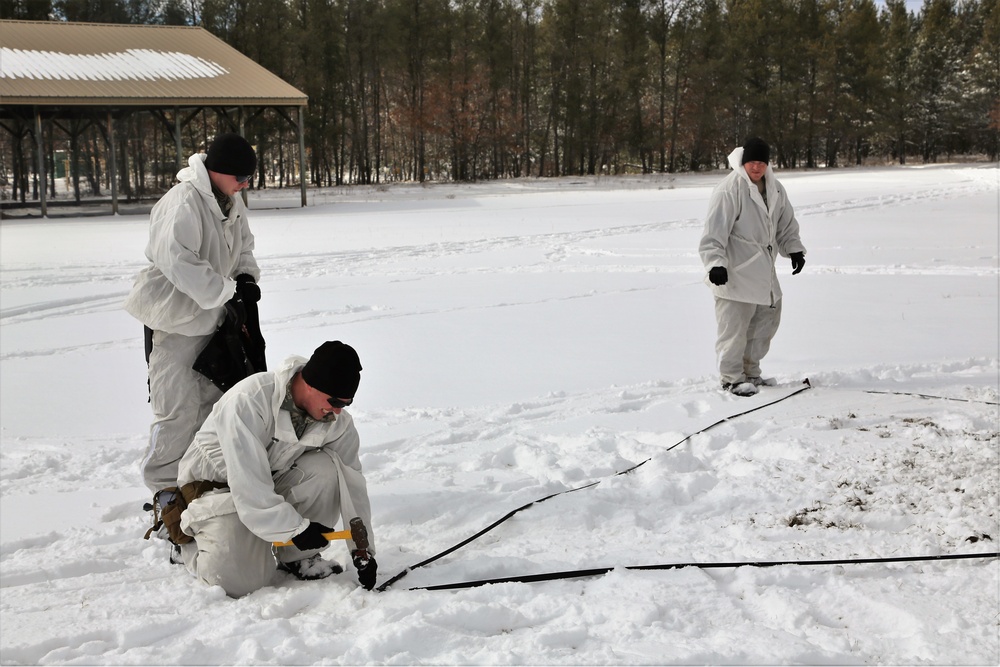 Cold-Weather Operations Course Class 18-06 students build Arctic tents during training at Fort McCoy