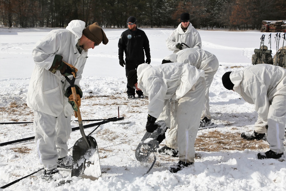 Cold-Weather Operations Course Class 18-06 students build Arctic tents during training at Fort McCoy