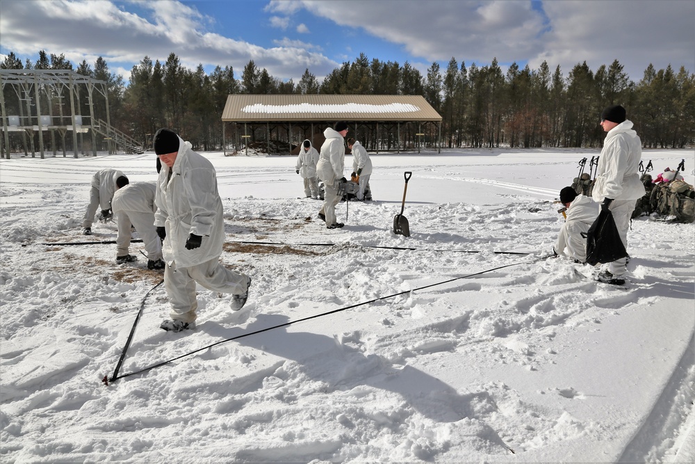 Cold-Weather Operations Course Class 18-06 students build Arctic tents during training at Fort McCoy