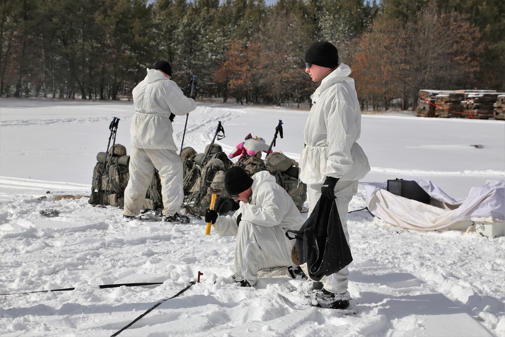 Cold-Weather Operations Course Class 18-06 students build Arctic tents during training at Fort McCoy