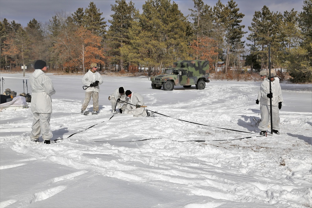 Cold-Weather Operations Course Class 18-06 students build Arctic tents during training at Fort McCoy