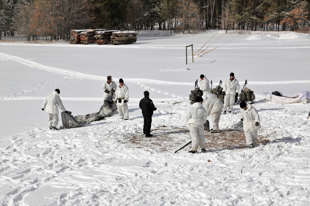 Cold-Weather Operations Course Class 18-06 students build Arctic tents during training at Fort McCoy