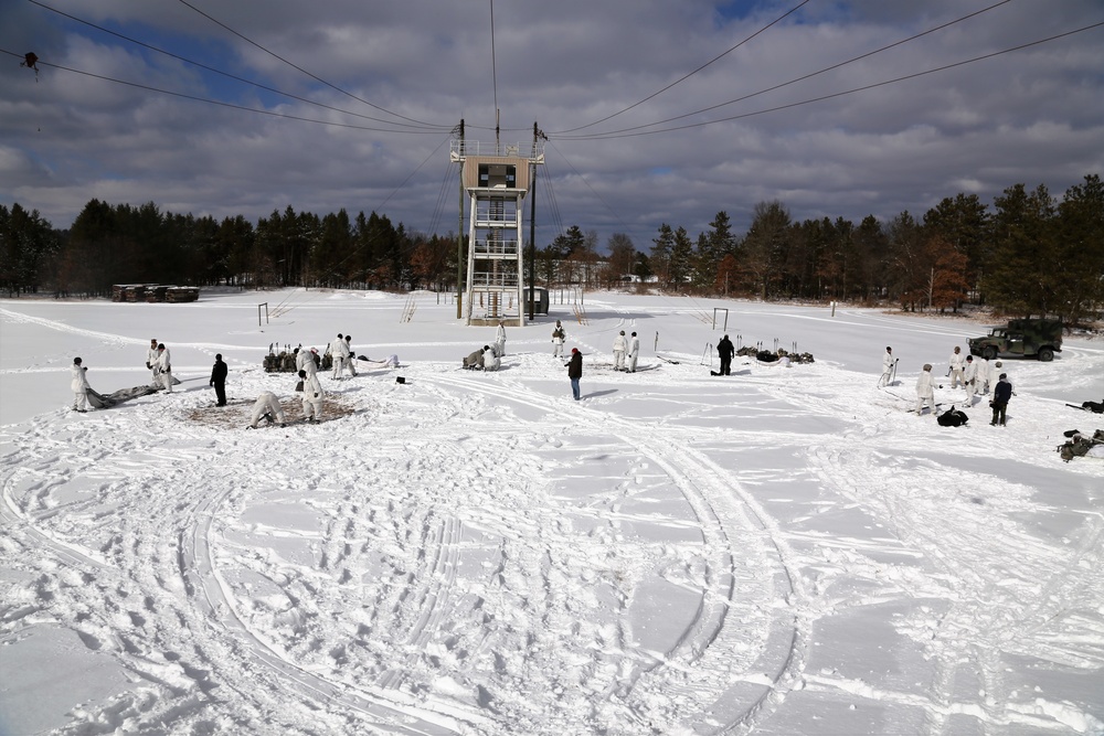 Cold-Weather Operations Course Class 18-04 students build Arctic tents during training at Fort McCoy