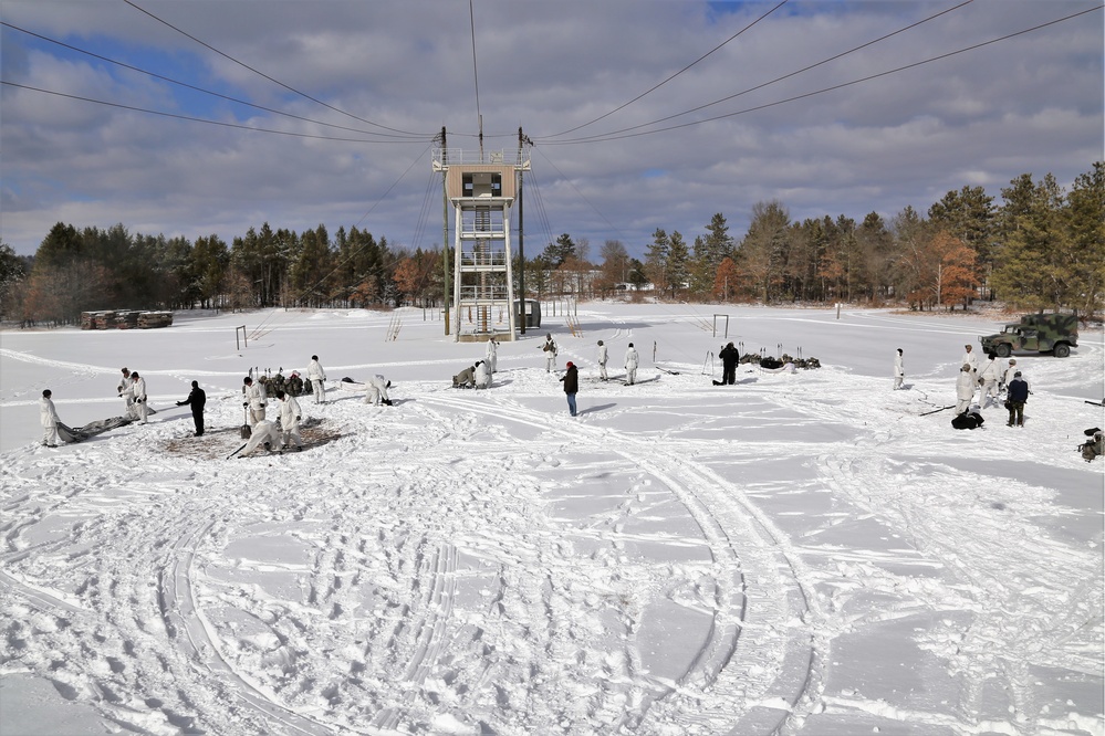 Cold-Weather Operations Course Class 18-04 students build Arctic tents during training at Fort McCoy