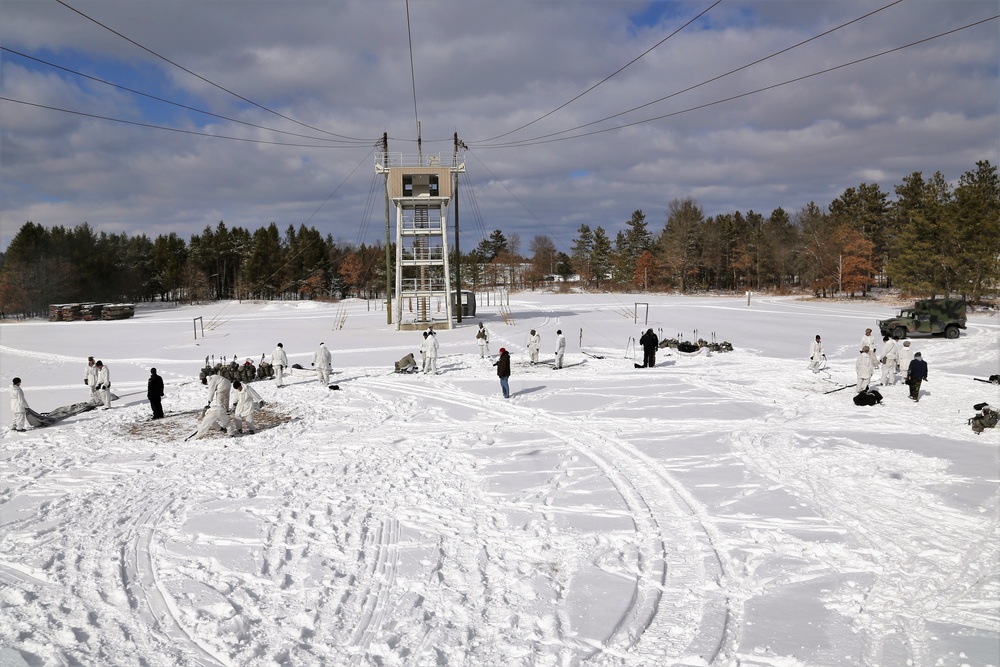 Cold-Weather Operations Course Class 18-06 students build Arctic tents during training at Fort McCoy