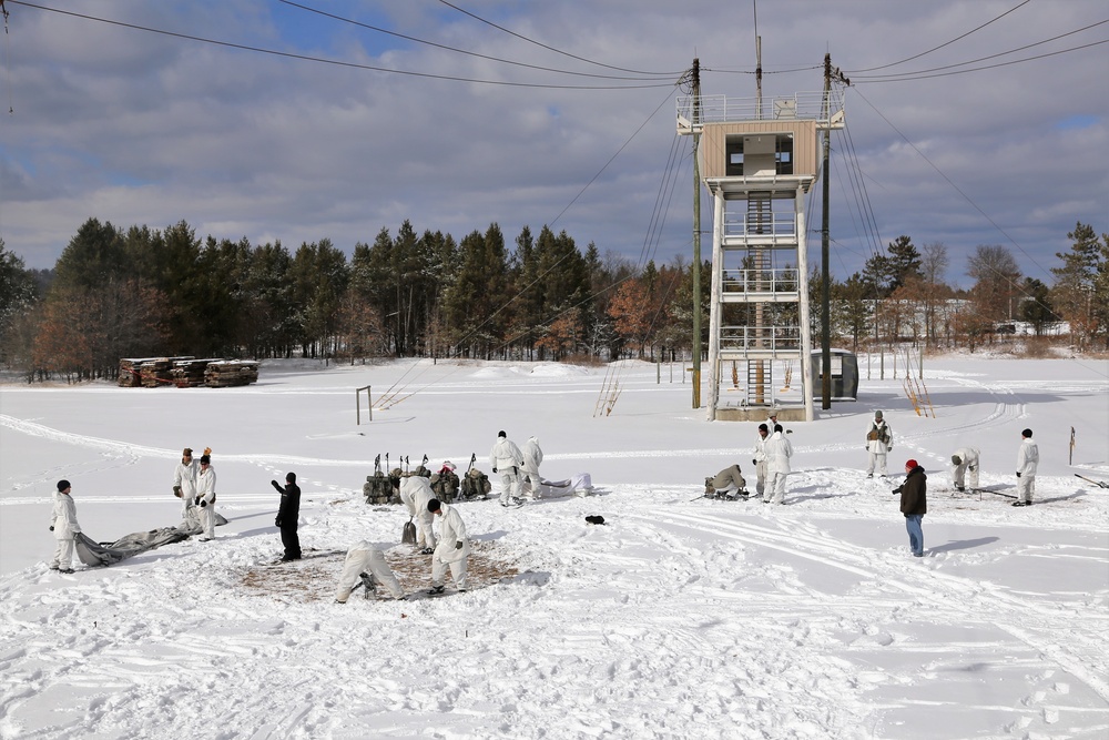 Cold-Weather Operations Course Class 18-06 students build Arctic tents during training at Fort McCoy