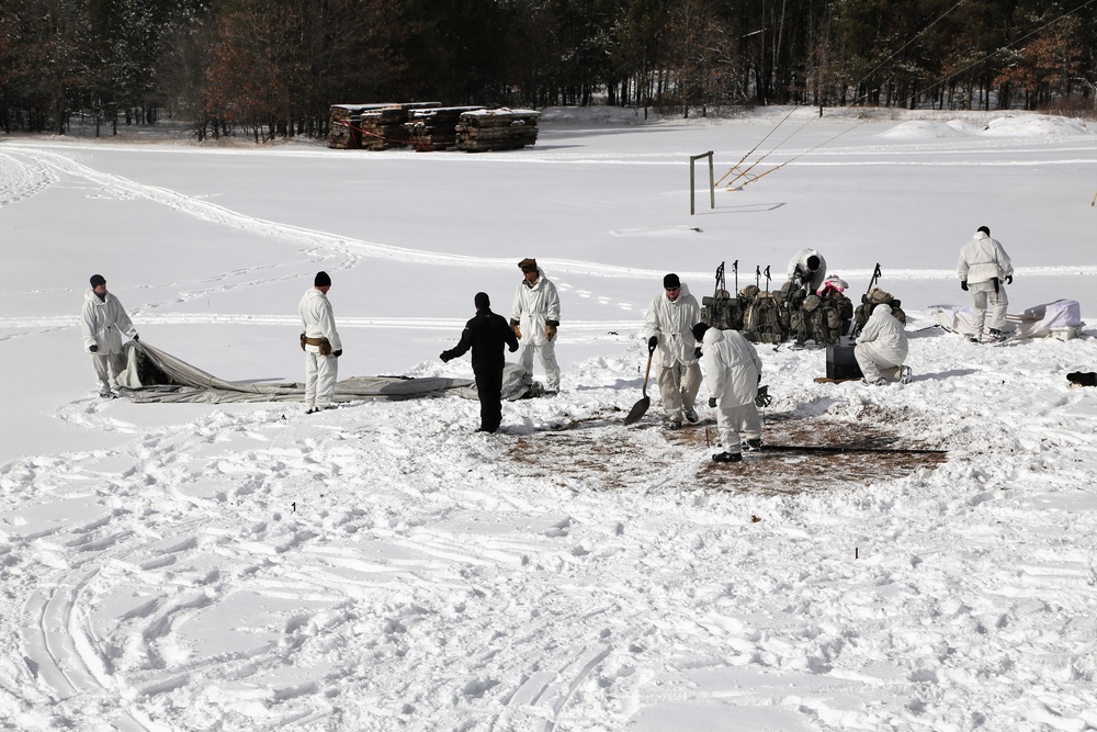 Cold-Weather Operations Course Class 18-06 students build Arctic tents during training at Fort McCoy