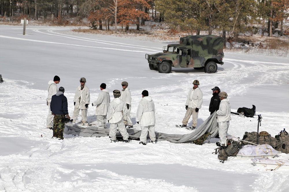 Cold-Weather Operations Course Class 18-06 students build Arctic tents during training at Fort McCoy