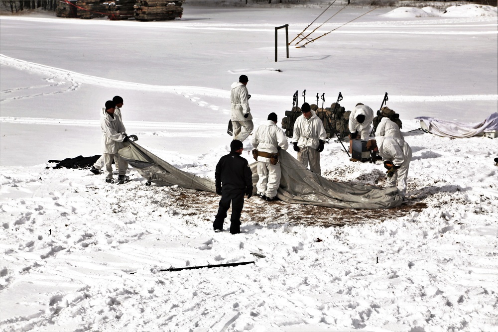 Cold-Weather Operations Course Class 18-06 students build Arctic tents during training at Fort McCoy