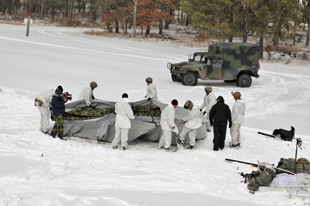 Cold-Weather Operations Course Class 18-06 students build Arctic tents during training at Fort McCoy