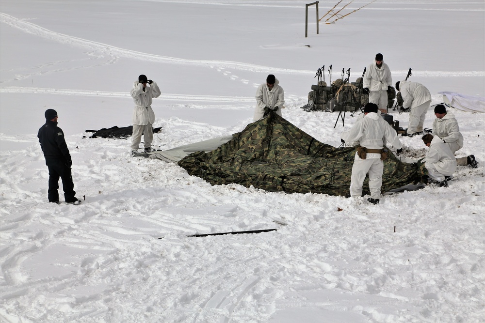 Cold-Weather Operations Course Class 18-06 students build Arctic tents during training at Fort McCoy