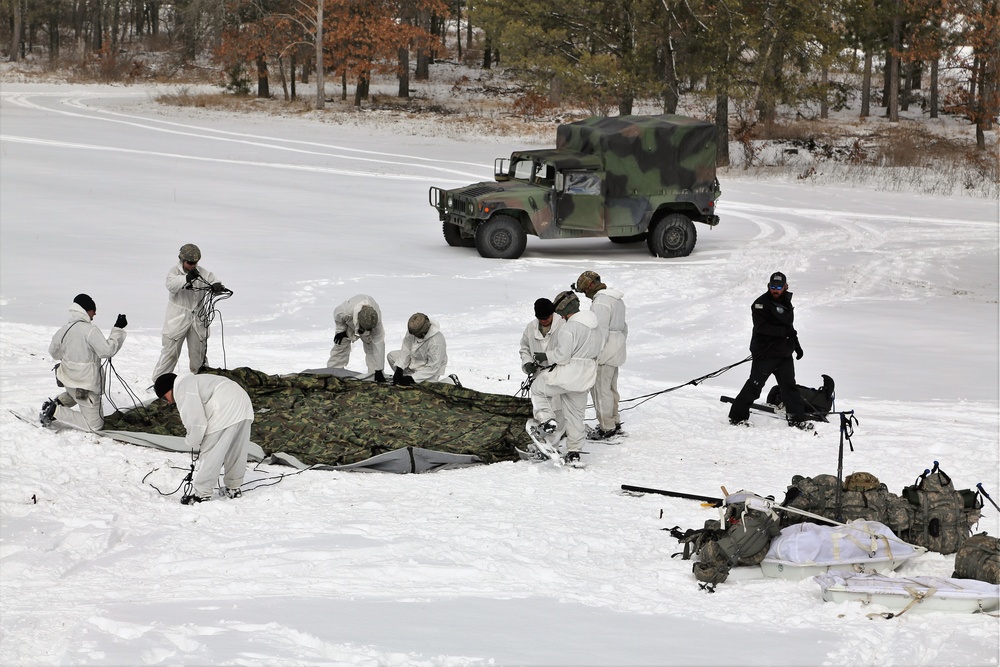 Cold-Weather Operations Course Class 18-04 students build Arctic tents during training at Fort McCoy