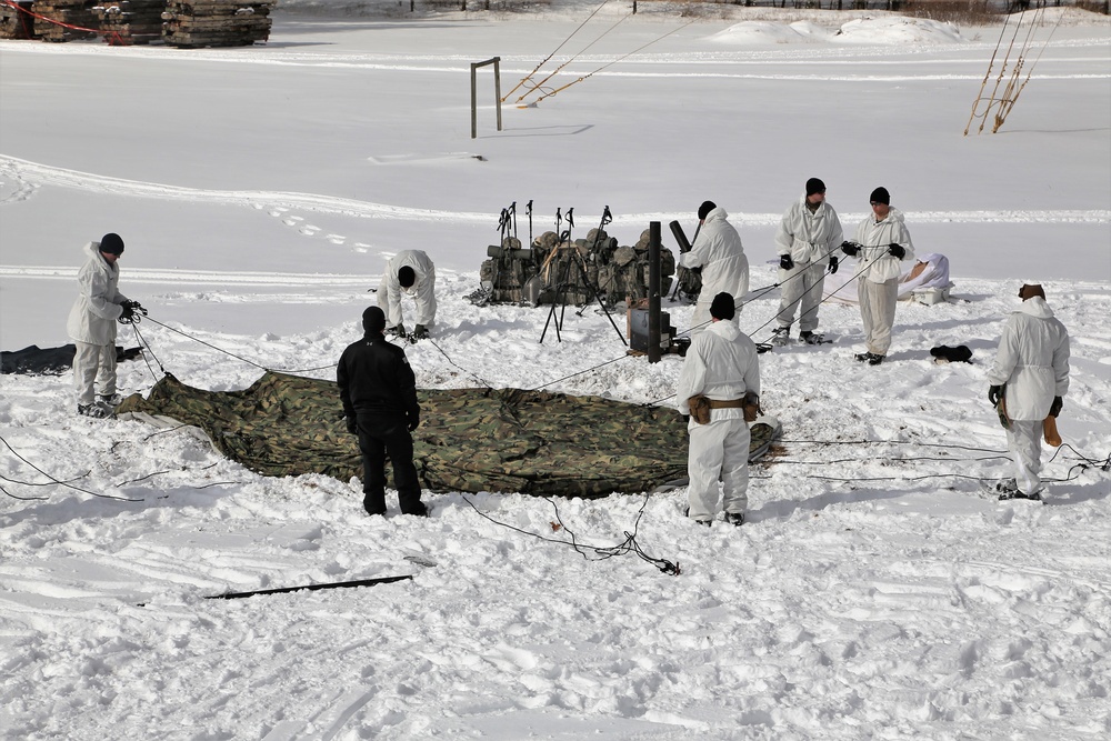 Cold-Weather Operations Course Class 18-04 students build Arctic tents during training at Fort McCoy