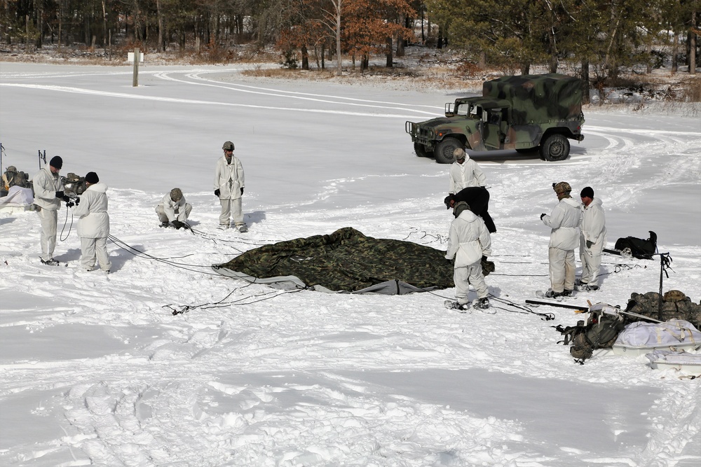 Cold-Weather Operations Course Class 18-04 students build Arctic tents during training at Fort McCoy