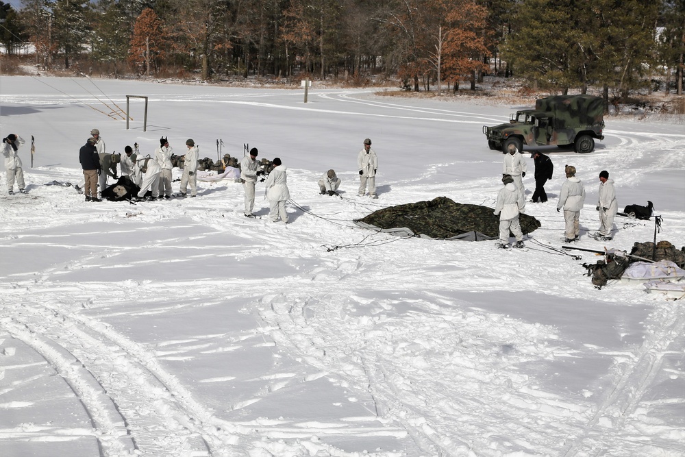 Cold-Weather Operations Course Class 18-04 students build Arctic tents during training at Fort McCoy