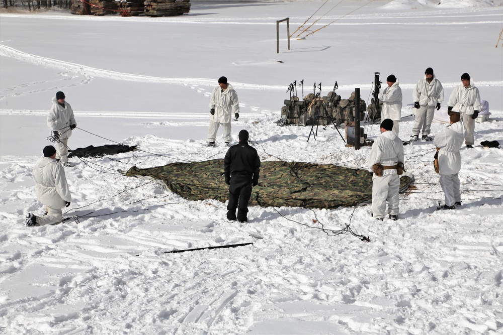 Cold-Weather Operations Course Class 18-04 students build Arctic tents during training at Fort McCoy