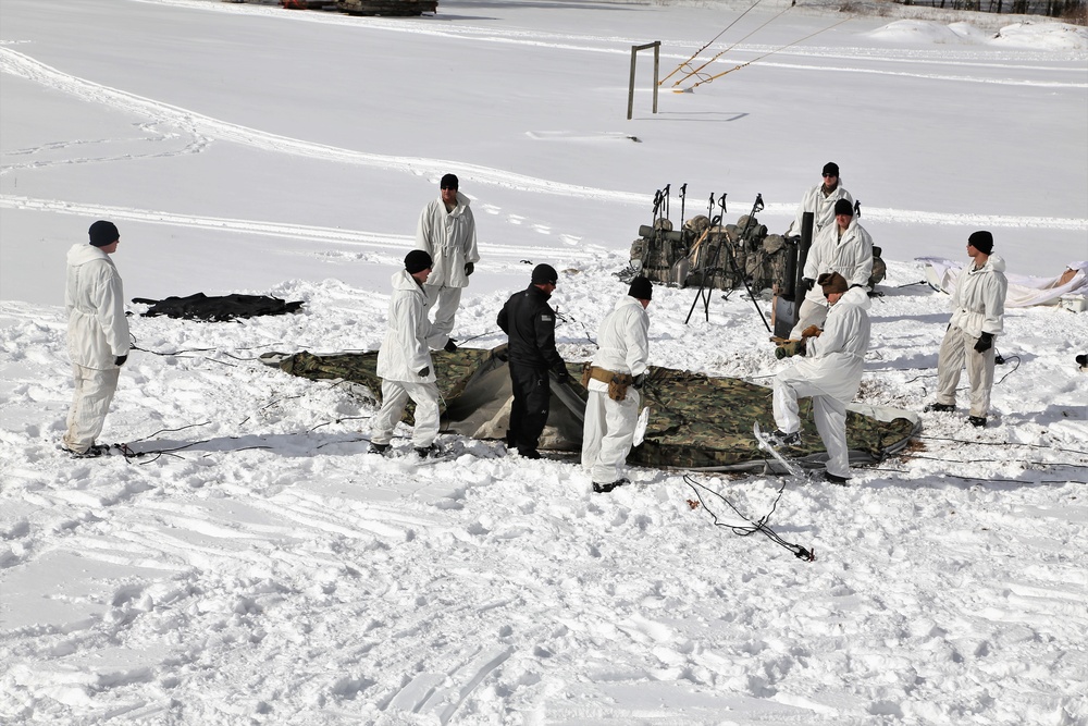 Cold-Weather Operations Course Class 18-04 students build Arctic tents during training at Fort McCoy