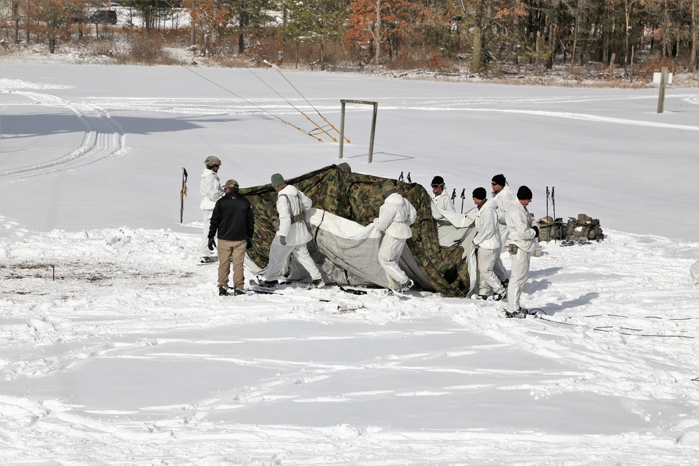 Cold-Weather Operations Course Class 18-04 students build Arctic tents during training at Fort McCoy