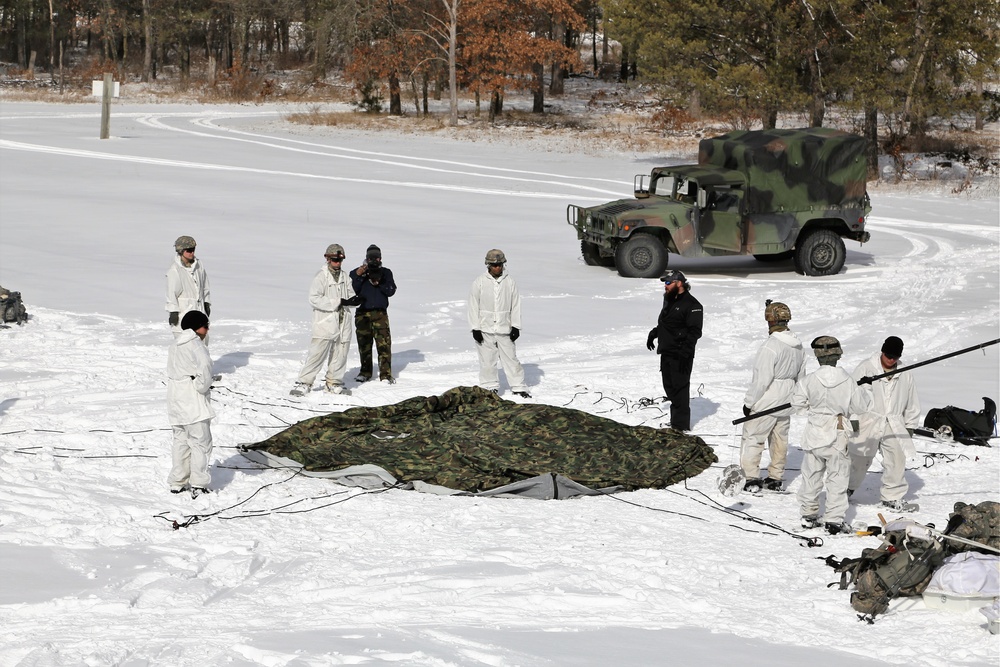 Cold-Weather Operations Course Class 18-04 students build Arctic tents during training at Fort McCoy