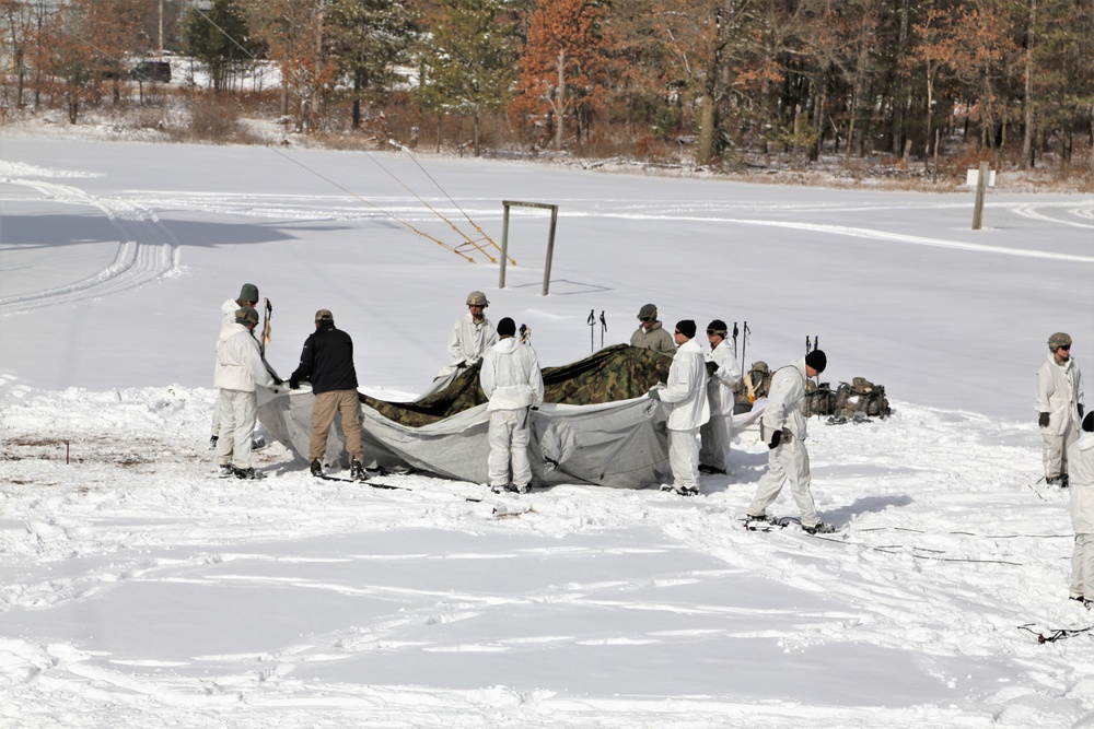 Cold-Weather Operations Course Class 18-04 students build Arctic tents during training at Fort McCoy