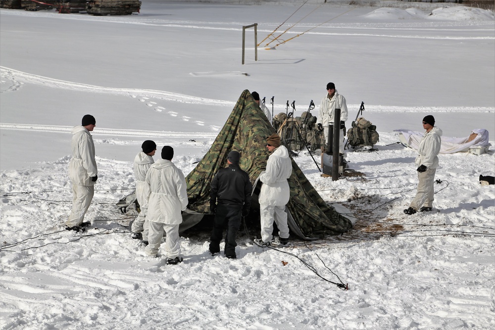 Cold-Weather Operations Course Class 18-04 students build Arctic tents during training at Fort McCoy