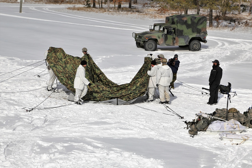 Cold-Weather Operations Course Class 18-06 students build Arctic tents during training at Fort McCoy