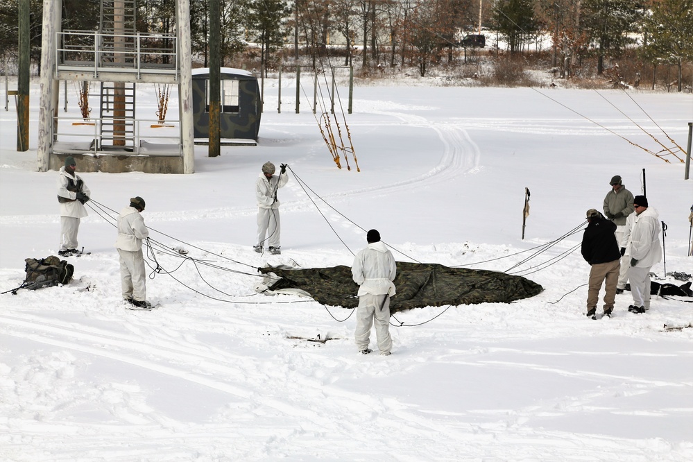 Cold-Weather Operations Course Class 18-06 students build Arctic tents during training at Fort McCoy