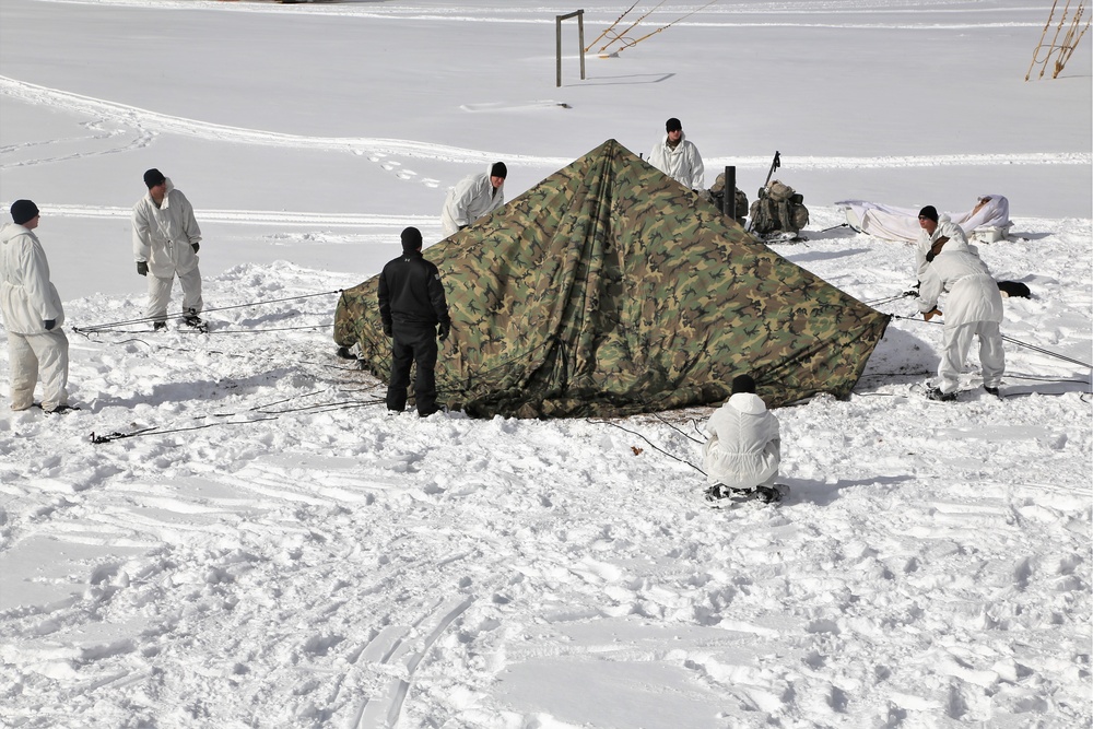 Cold-Weather Operations Course Class 18-06 students build Arctic tents during training at Fort McCoy