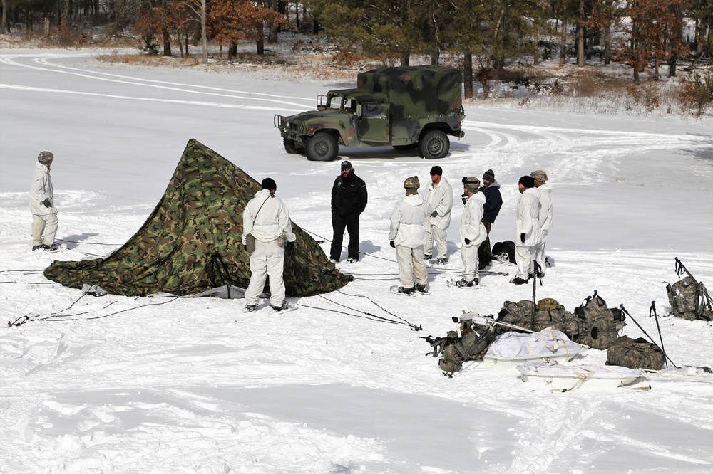 Cold-Weather Operations Course Class 18-06 students build Arctic tents during training at Fort McCoy