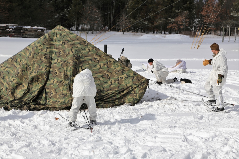 Cold-Weather Operations Course Class 18-06 students build Arctic tents during training at Fort McCoy