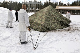 Cold-Weather Operations Course Class 18-06 students build Arctic tents during training at Fort McCoy