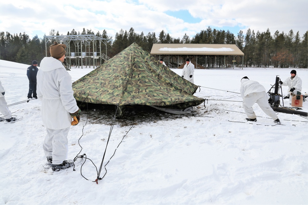 Cold-Weather Operations Course Class 18-06 students build Arctic tents during training at Fort McCoy