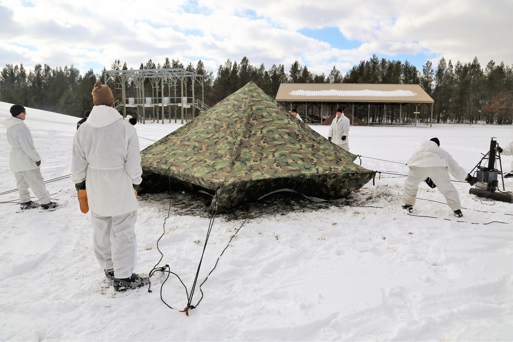 Cold-Weather Operations Course Class 18-06 students build Arctic tents during training at Fort McCoy