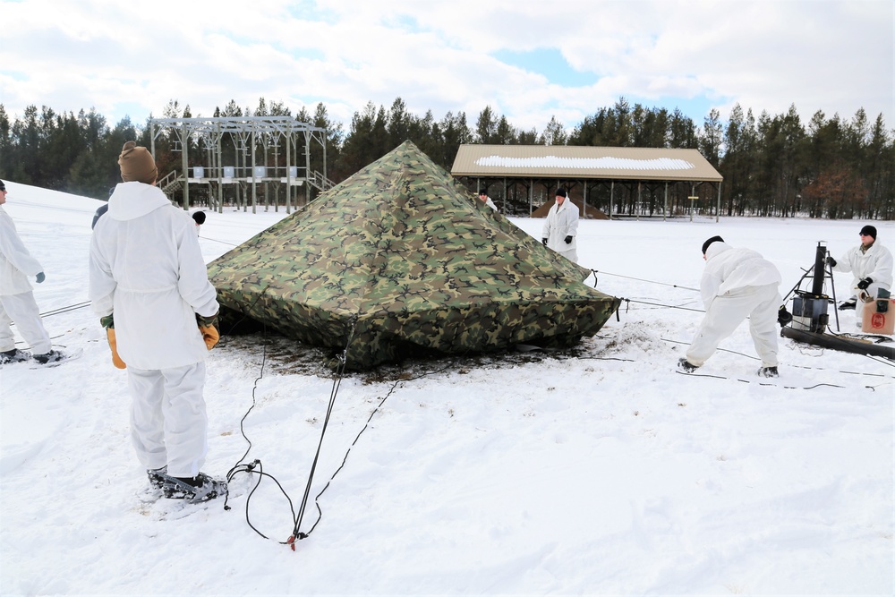 Cold-Weather Operations Course Class 18-06 students build Arctic tents during training at Fort McCoy