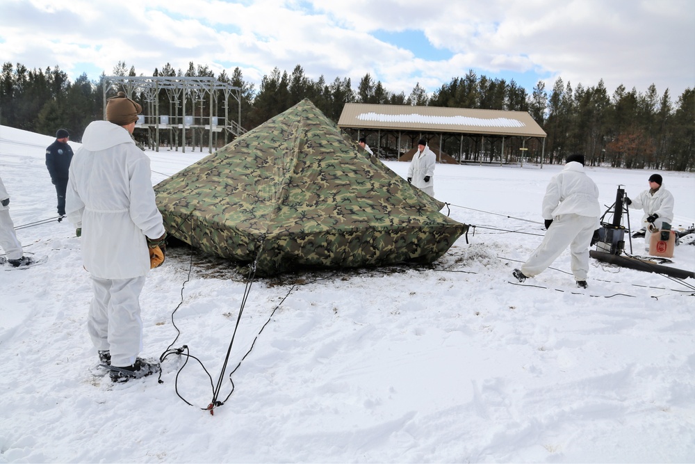 Cold-Weather Operations Course Class 18-06 students build Arctic tents during training at Fort McCoy