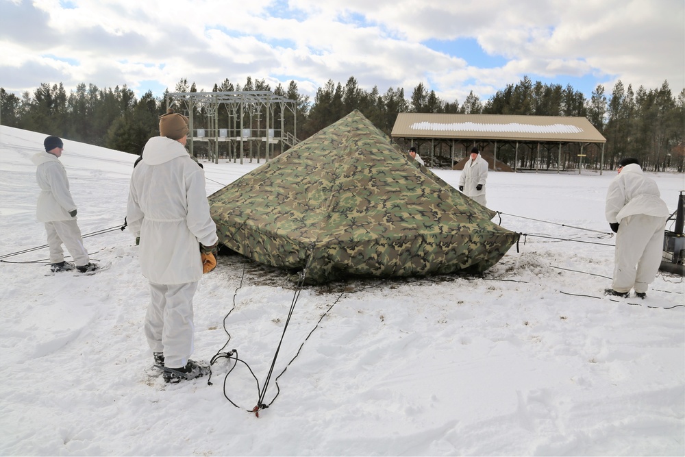 Cold-Weather Operations Course Class 18-06 students build Arctic tents during training at Fort McCoy