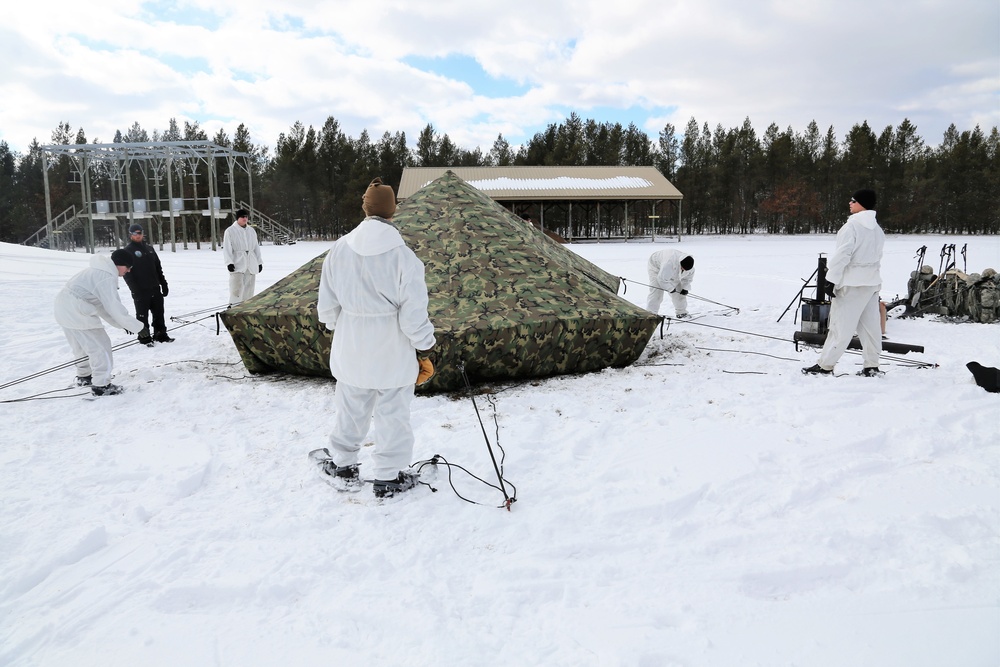 Cold-Weather Operations Course Class 18-06 students build Arctic tents during training at Fort McCoy