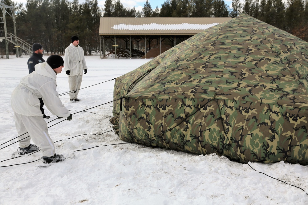 Cold-Weather Operations Course Class 18-06 students build Arctic tents during training at Fort McCoy