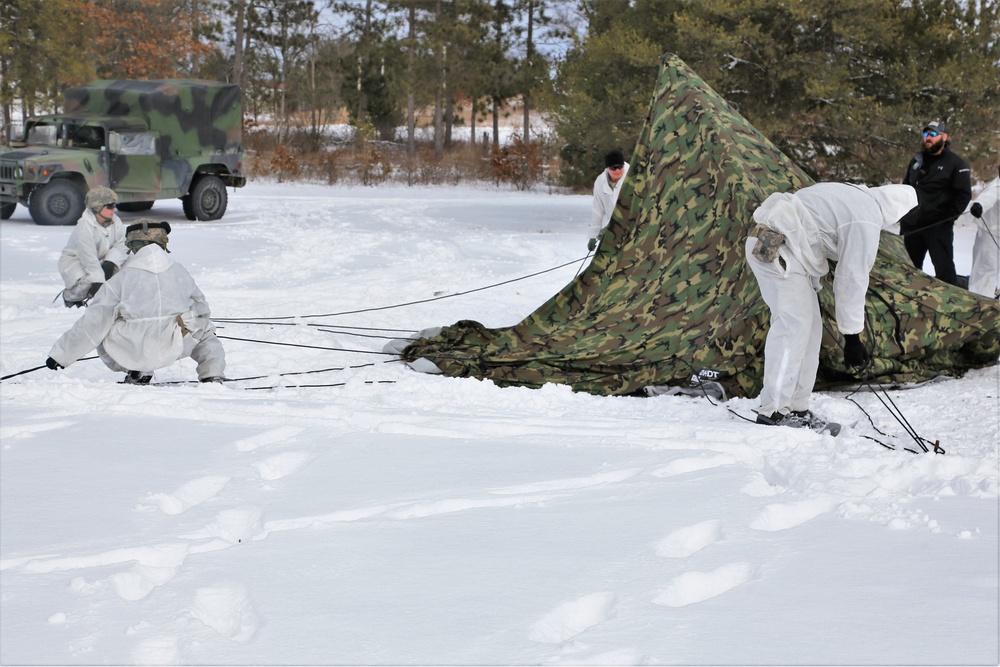 Cold-Weather Operations Course Class 18-06 students build Arctic tents during training at Fort McCoy