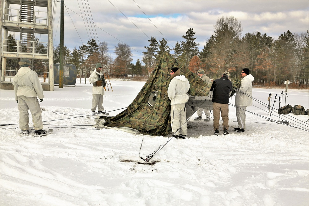 Cold-Weather Operations Course Class 18-06 students build Arctic tents during training at Fort McCoy