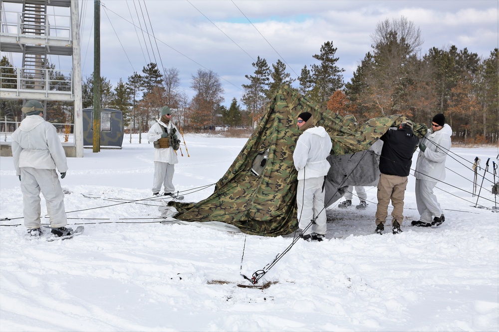 Cold-Weather Operations Course Class 18-06 students build Arctic tents during training at Fort McCoy