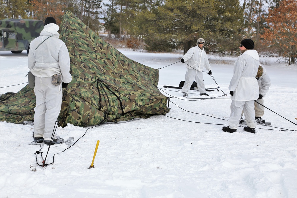 Cold-Weather Operations Course Class 18-06 students build Arctic tents during training at Fort McCoy