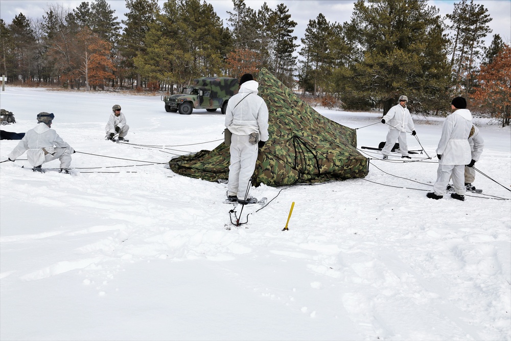 Cold-Weather Operations Course Class 18-06 students build Arctic tents during training at Fort McCoy