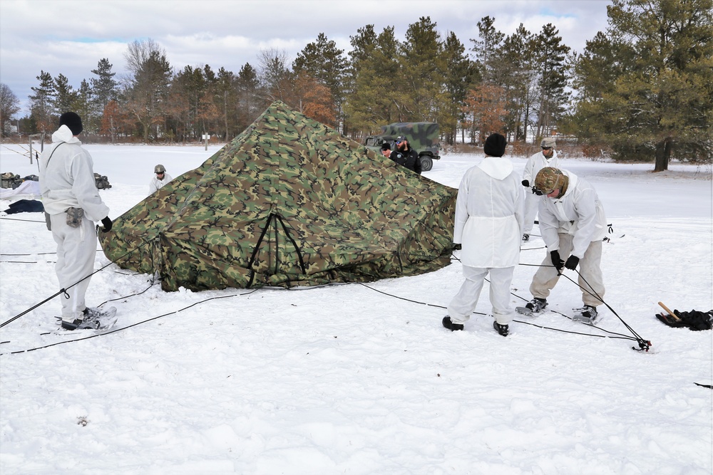 Cold-Weather Operations Course Class 18-06 students build Arctic tents during training at Fort McCoy