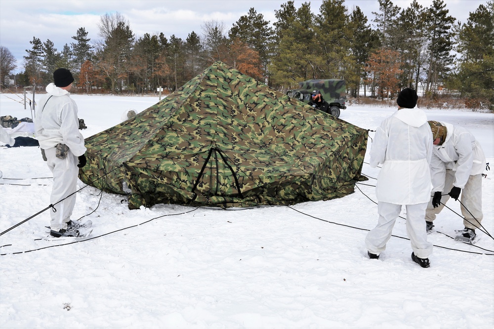 Cold-Weather Operations Course Class 18-06 students build Arctic tents during training at Fort McCoy