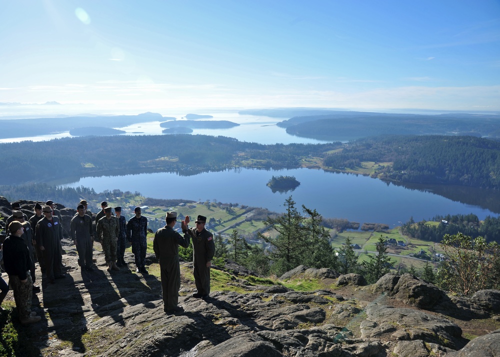 Lt. Cmdr. Justin Jennings reenlists AWO2 Fouche on Mt. Erie