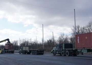 A Letterkenny Munitions Center employees unload shipping containers from the 1048th Transportation Company, Connecticut Army National Guard’s flatbed trailers in support of Operation Patriot Bandoleer.